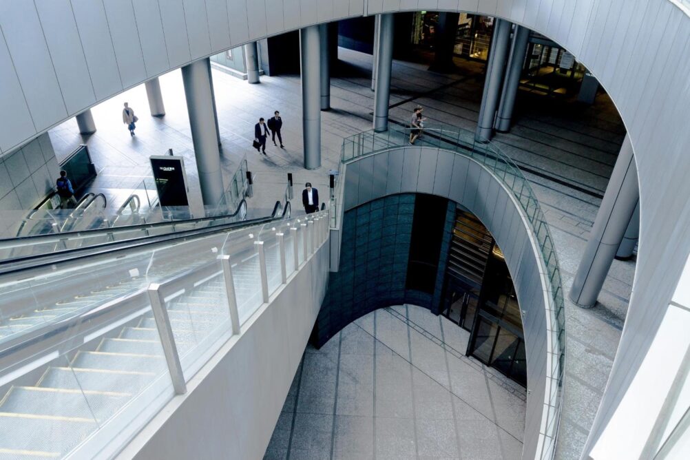 Upstairs view of a large curved modern building with columns from inside