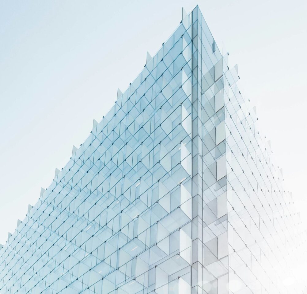 Pointed top of a high-rise glass building against the sky